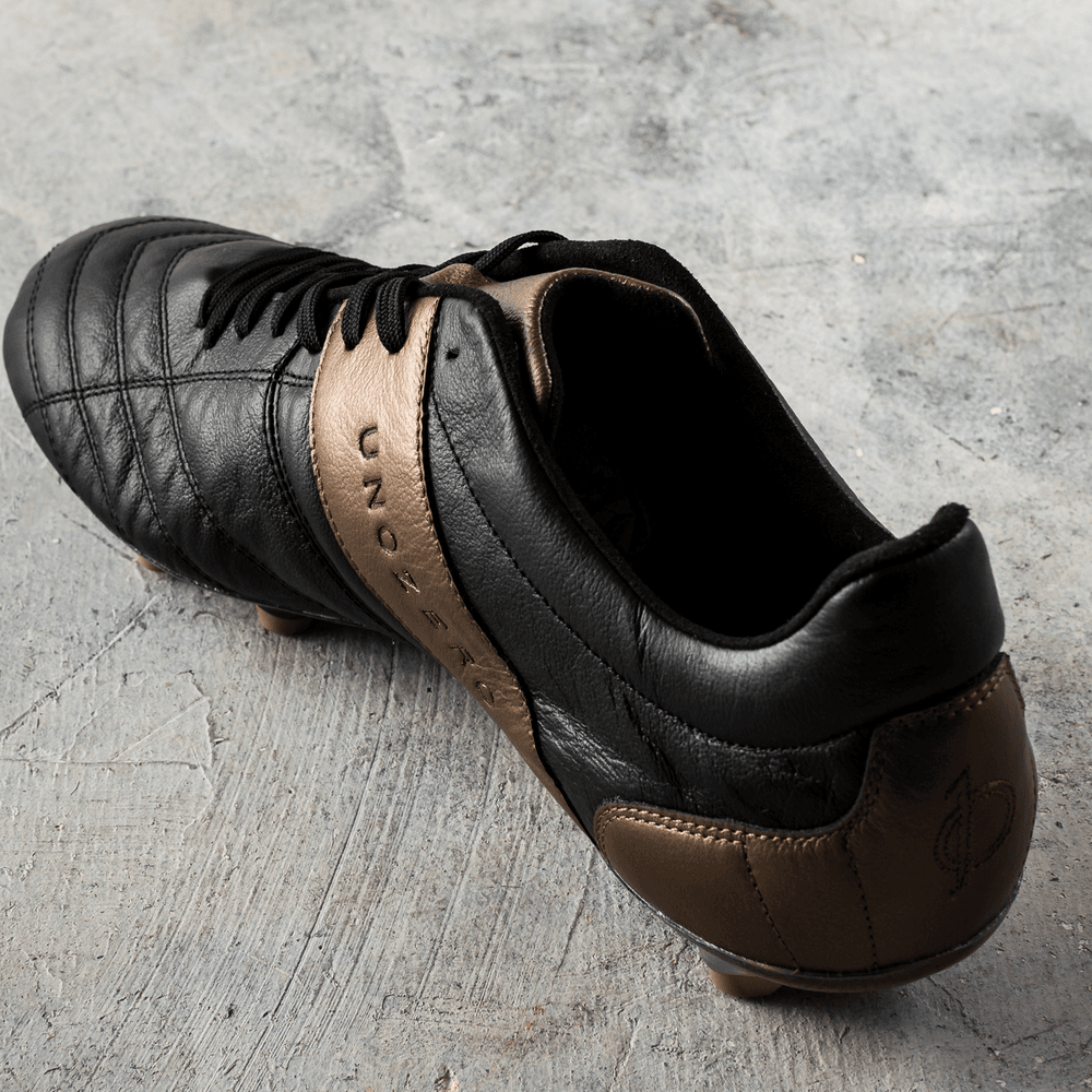 Unozero Modelo 1.0 Firm Ground Men's Soccer Cleats Black Gold