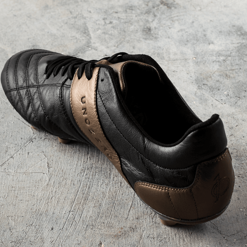 Load image into Gallery viewer, Unozero Modelo 1.0 Firm Ground Soccer Cleats Black Gold
